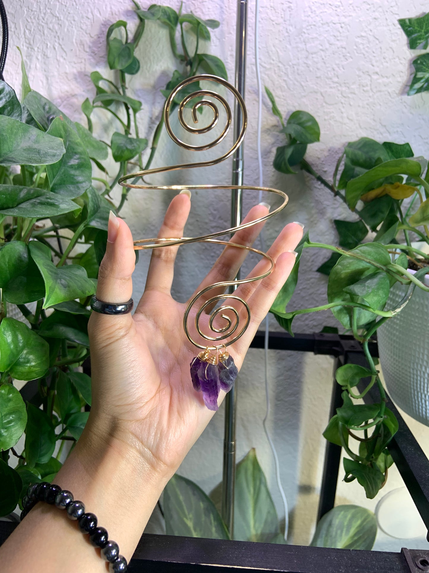 Golden spiral arm cuff with wire wrapped amethyst crystals