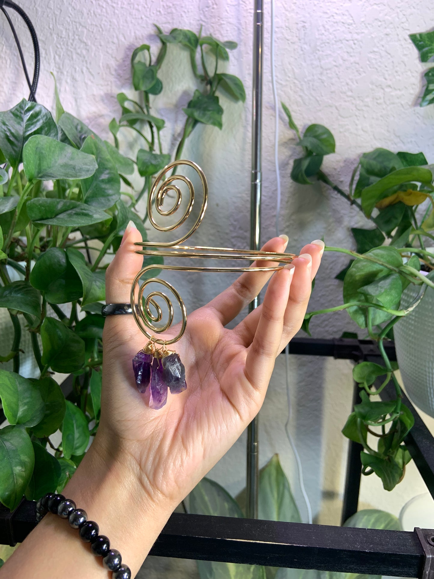 Golden spiral arm cuff with wire wrapped amethyst crystals