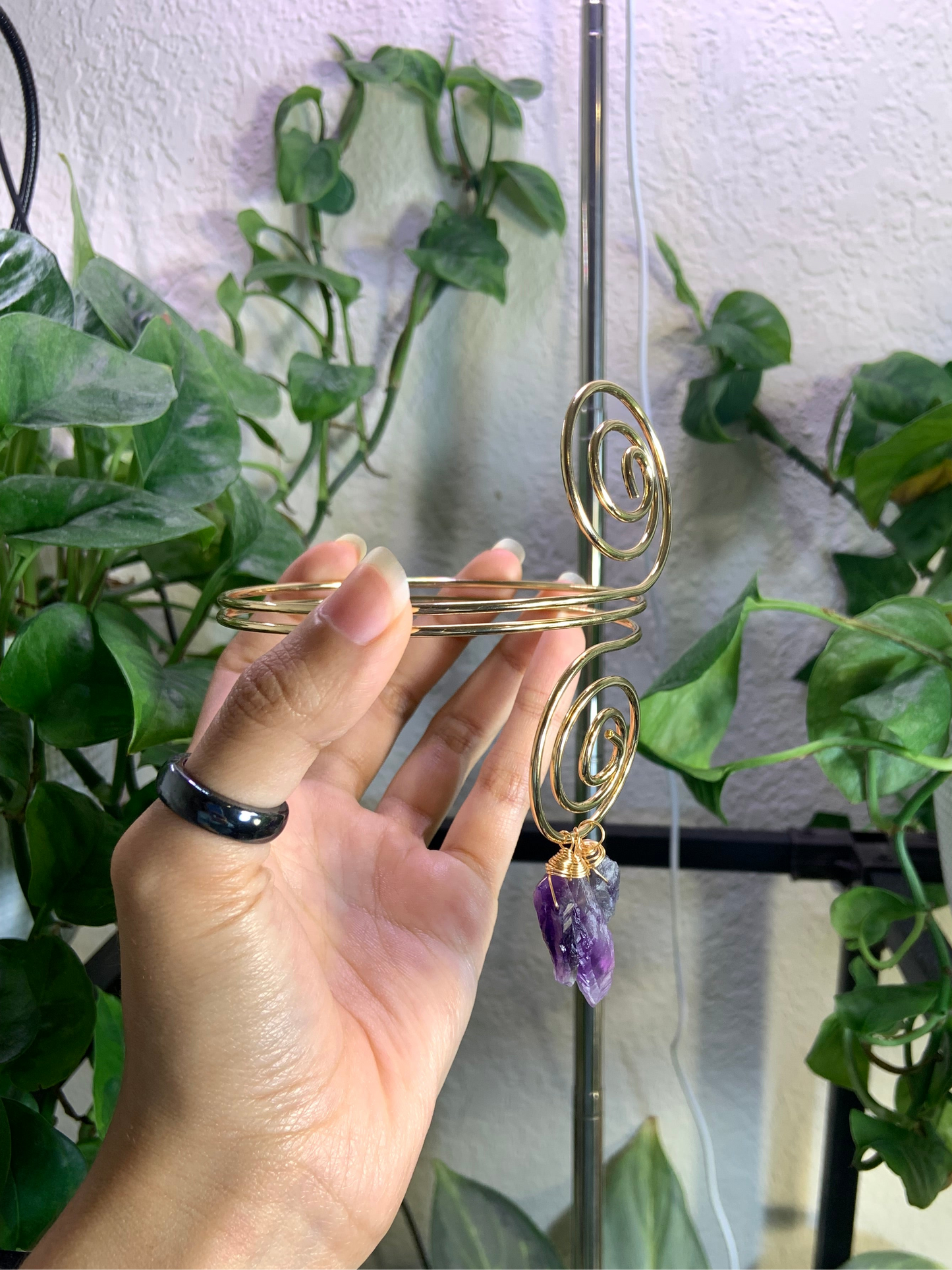 Golden spiral arm cuff with wire wrapped amethyst crystals